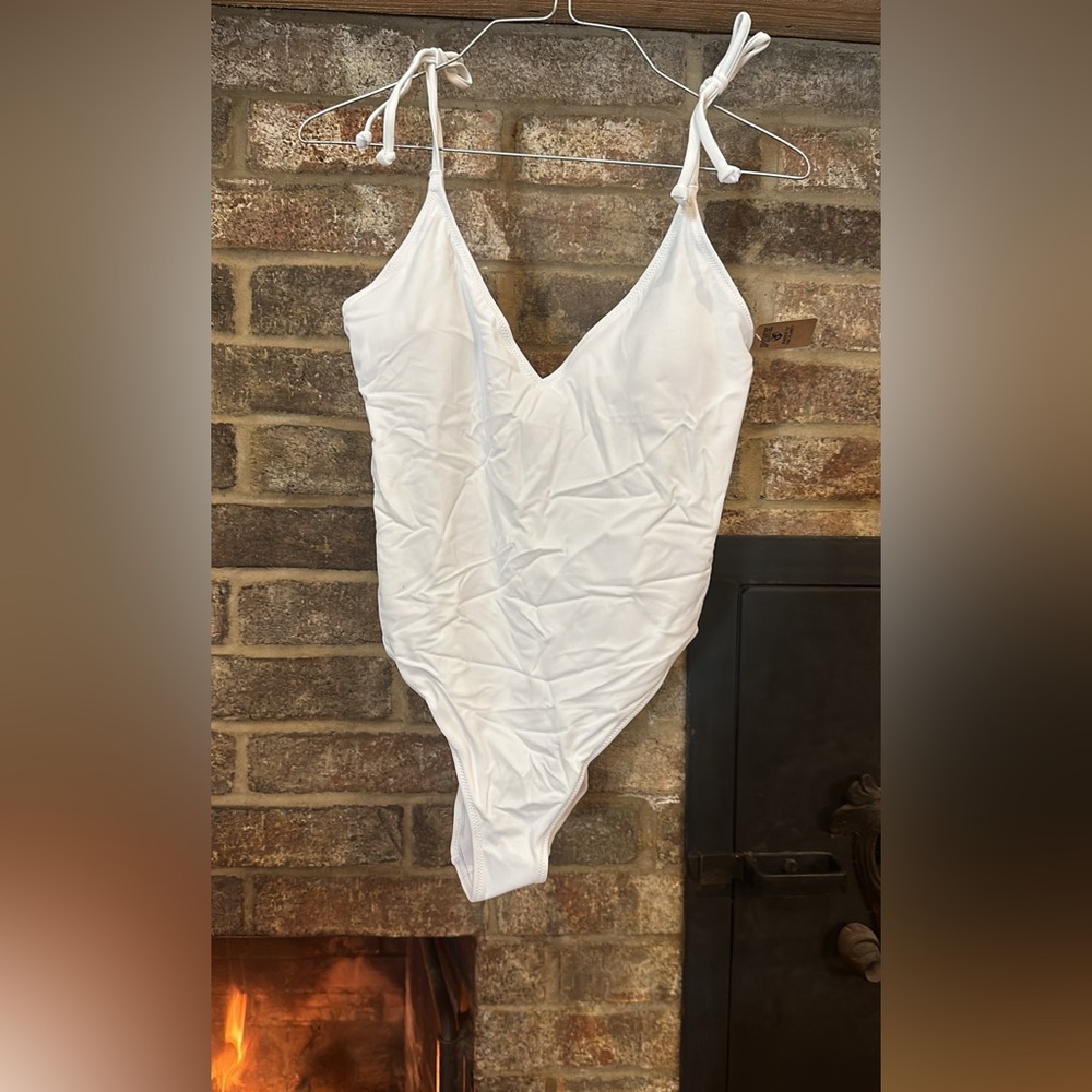 From the Victoria secret store. White one piece PINK brand bathing suit.